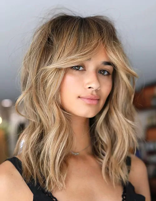 Shoulder-Length Blonde Waves With Soft Bangs